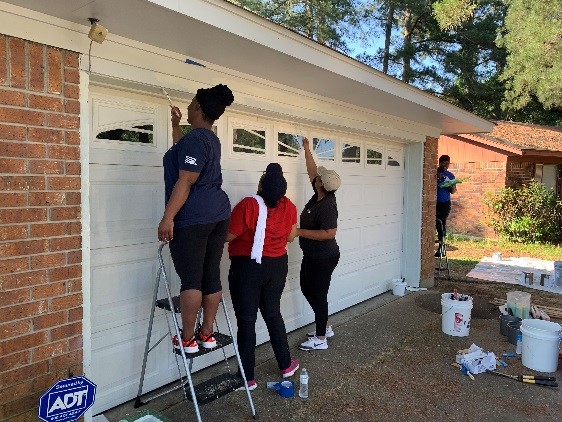 Employees participating in Paint Your Heart Out.  Painting homes for those in need.