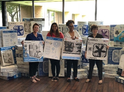 Employees donating fans for seniors during the hot summer months in Louisiana.  