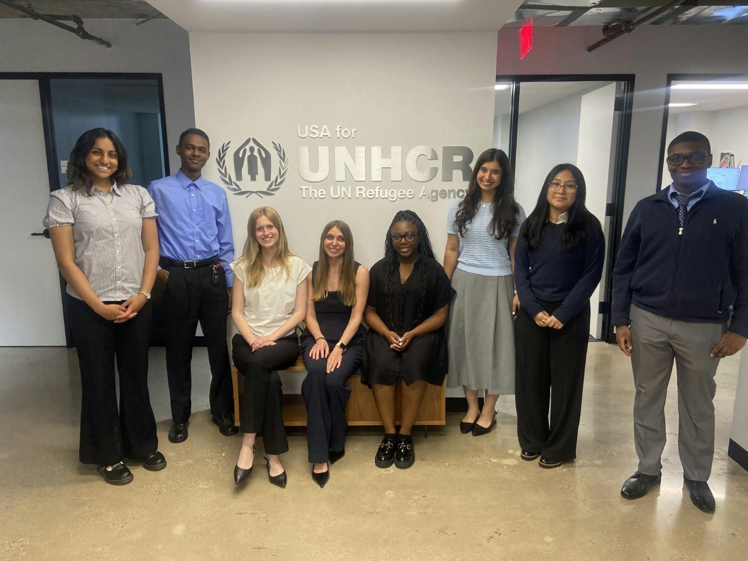 Nine interns, each representing a unique department at USA for UNHCR, celebrate their first day of the program. 