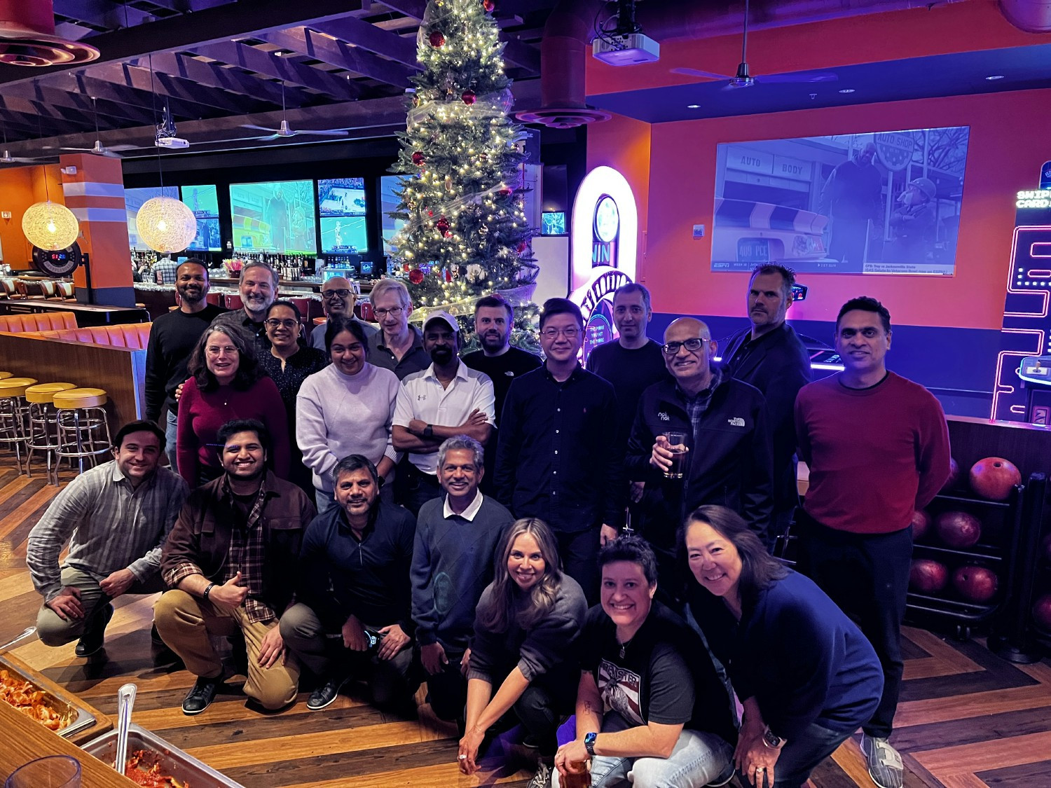 Team members enjoy a festive holiday bowling event, combining friendly competition and connection.