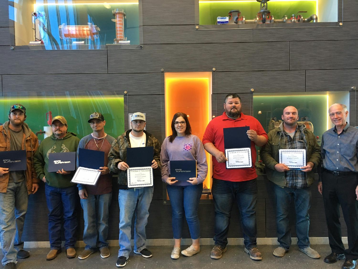 A group of Trade employees showing off their certificates marking their completion of the Safe Supervisor Course. These individuals gained knowledge and skills in OSHA Standards for the Construction Industry.