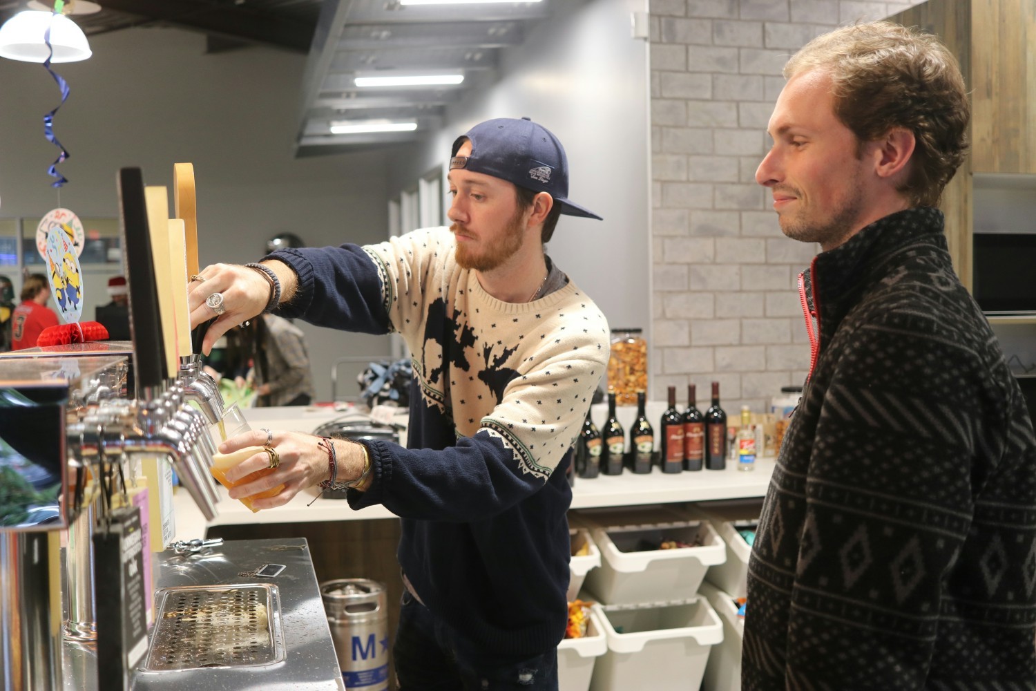 Pouring some beer from our many taps at the holiday party in 2022