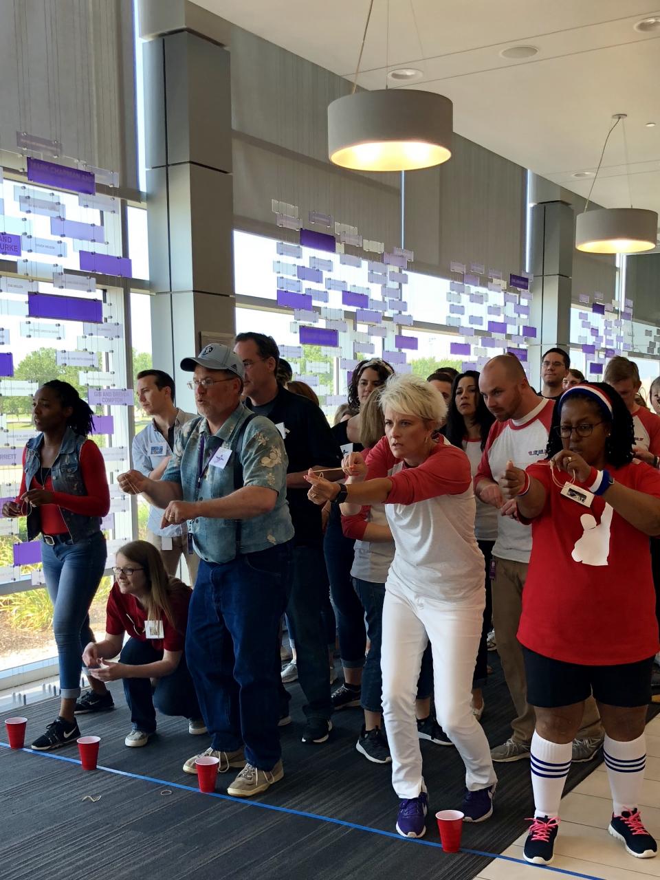 Team members competing in rubber band archery at the 2018 Summer Games