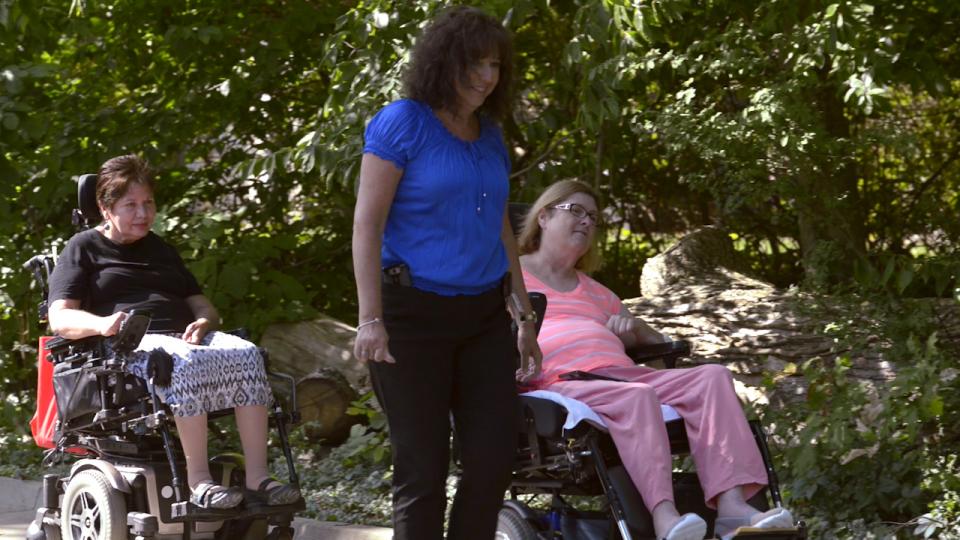 Director of Nursing walking with a resident