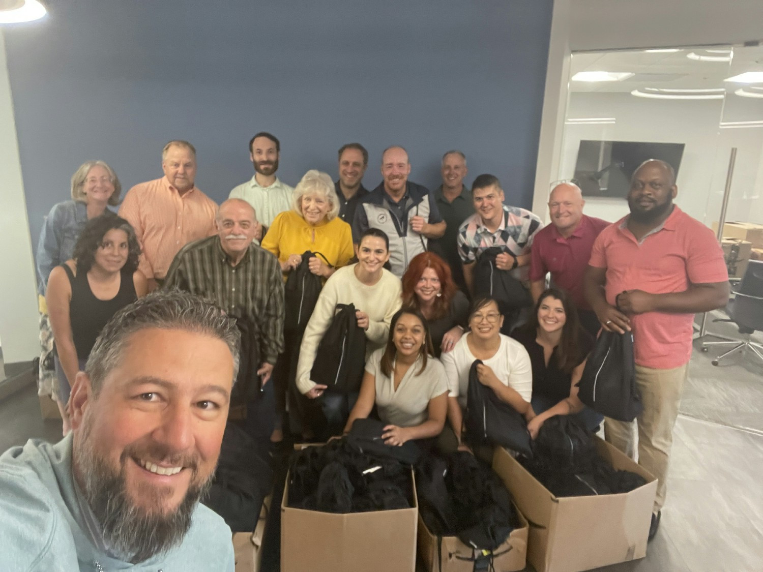 Giving back together! Partnering with A Wider Circle, team members assembled backpacks for the unhoused in our community