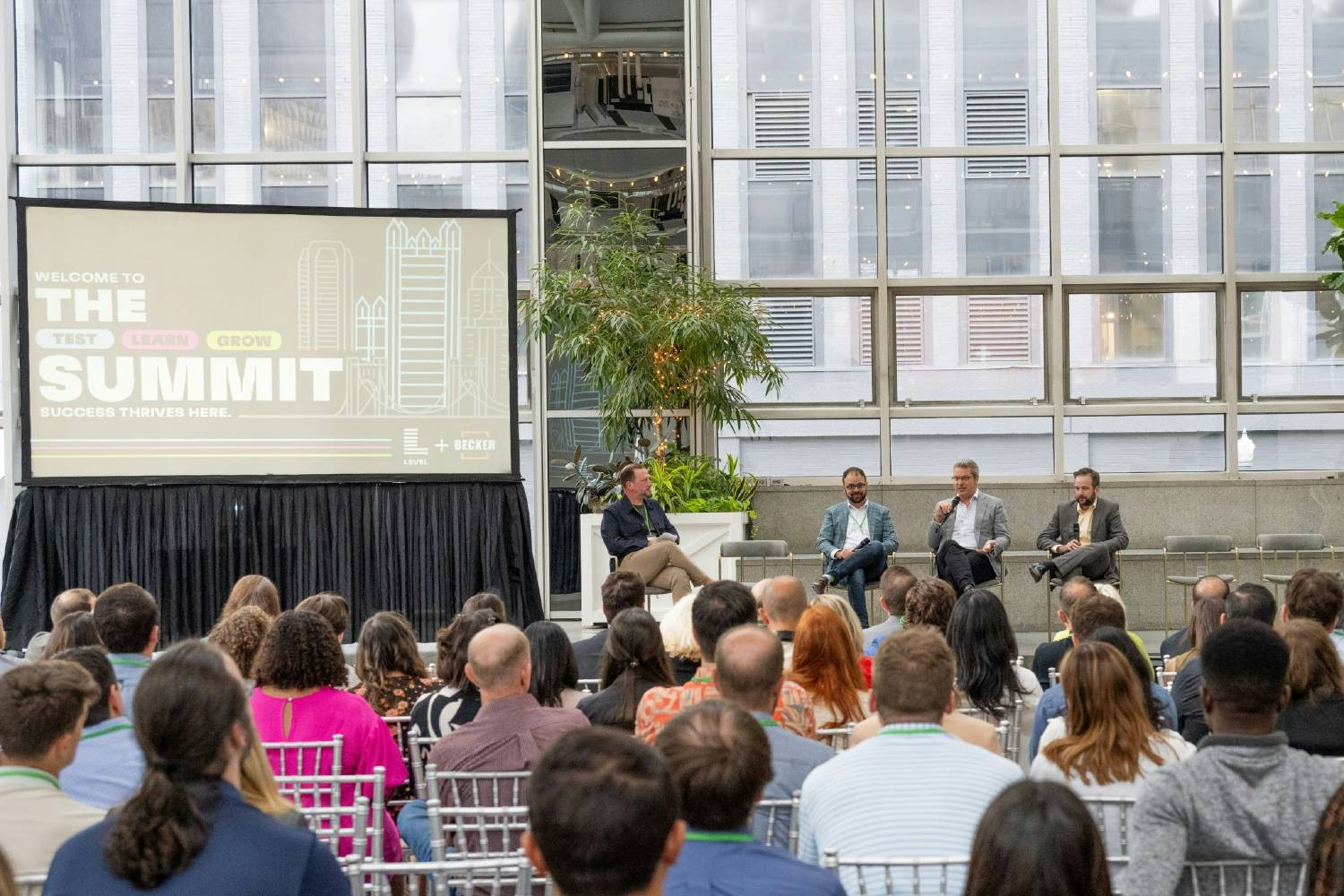 Our team listening to a panel of speakers at our annual Test Learn Grow Summit
