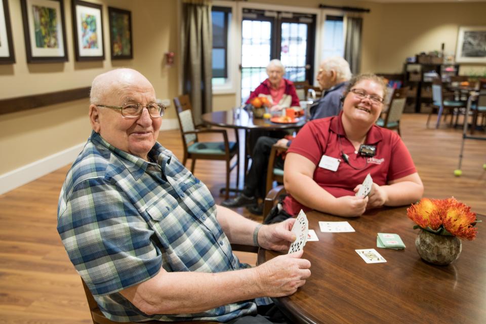 resident and associate having fun playing cards