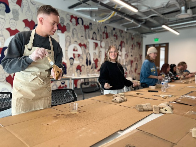 Weave employees participating in a team building art activity.
