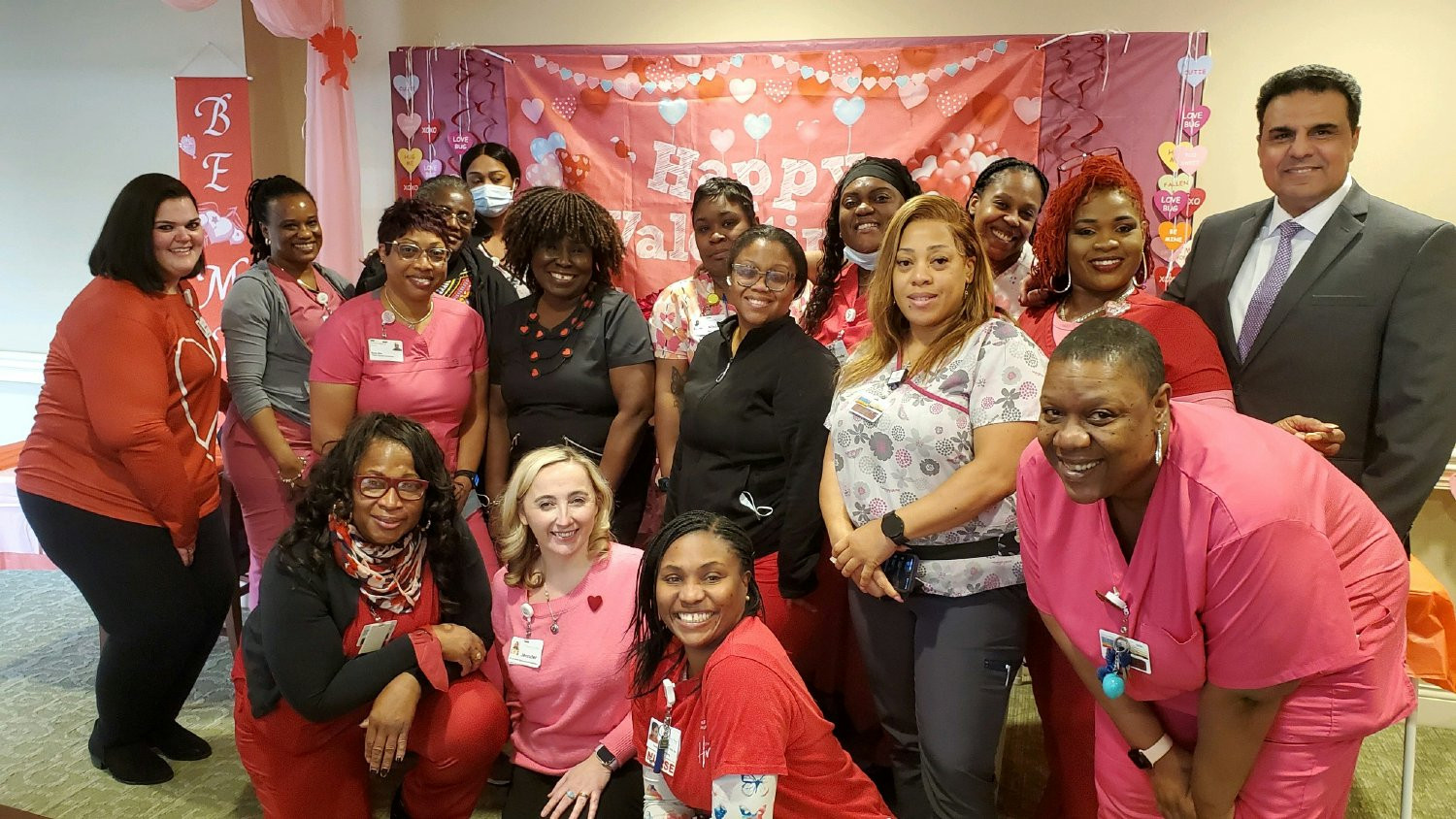 The nursing team takes a break from their Valentine's Day pot luck party for a picture.