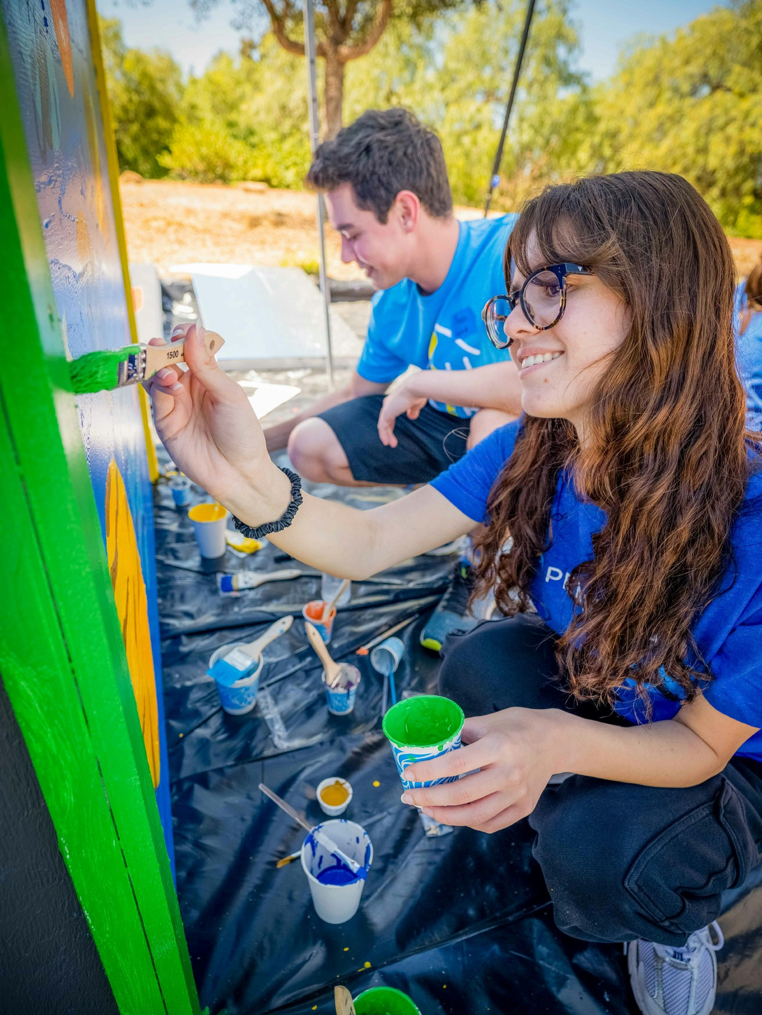 From laptops to paintbrushes! Our PCU Class of 2025 gives back with a Habitat for Humanity Playhouse Build Day.