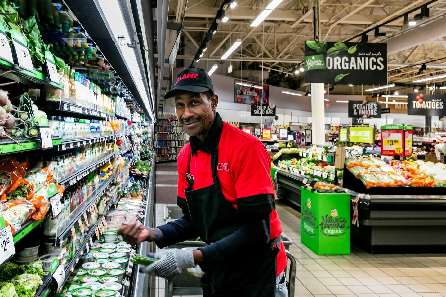 The GIANT Company produce team member, ensuring the shelves are stocked and ready for customers.