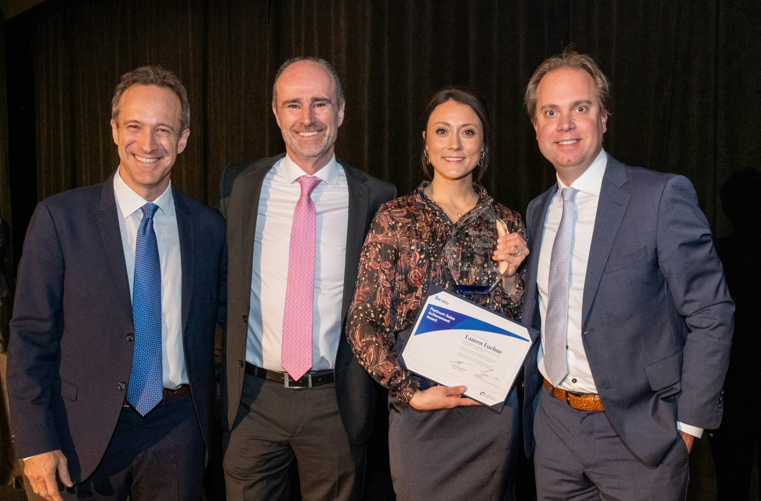 Lauren Feuhne is pictured receiving her sales excellence award from her manager and our IMCD Americas & US Presidents!