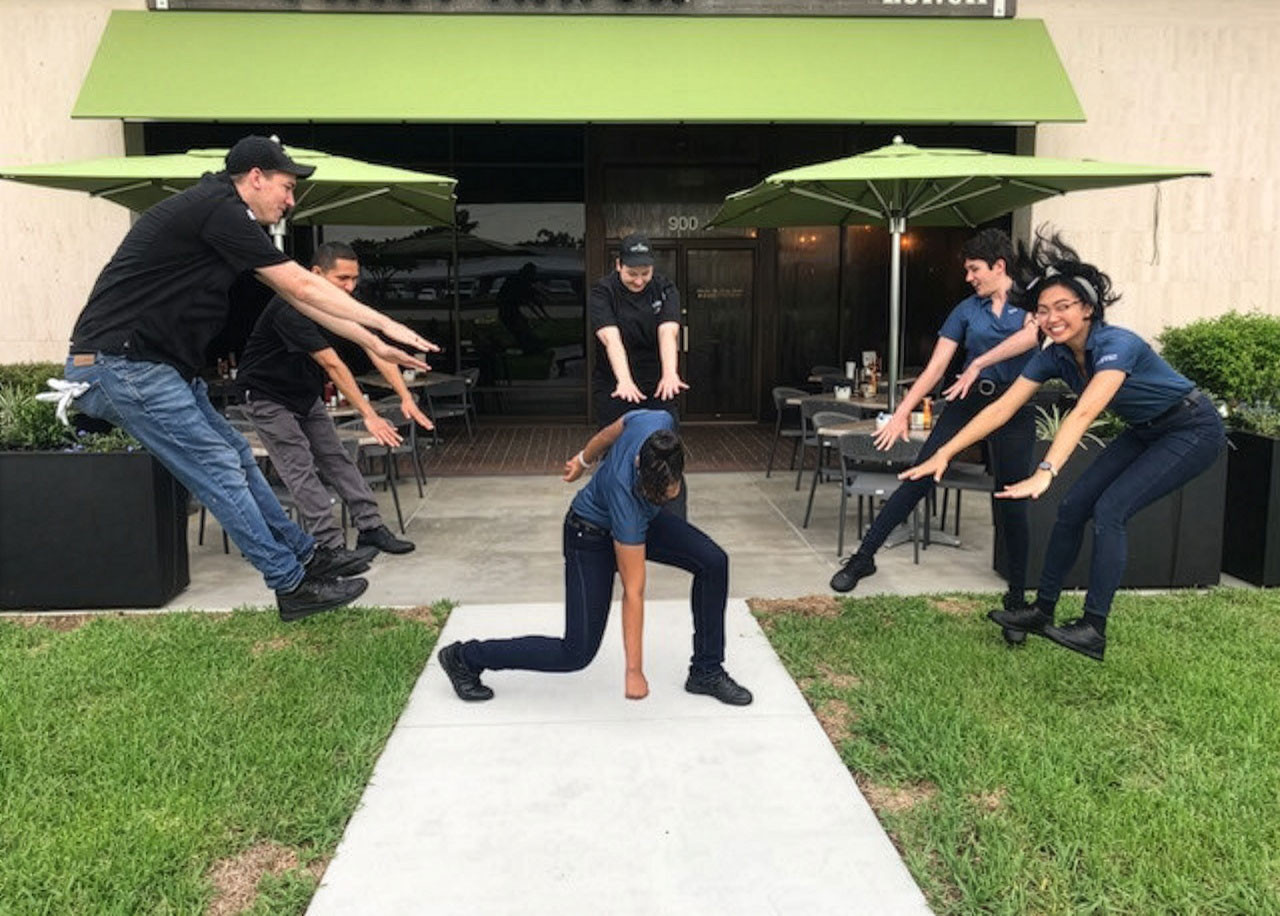 A 'superhero' team of restaurant trainers and team members celebrate a new First Watch restaurant opening