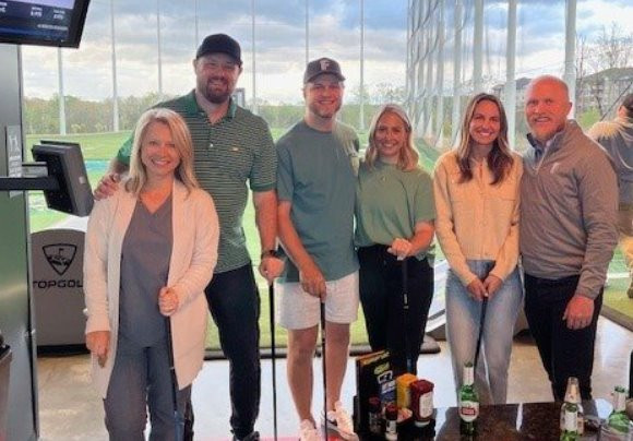 Letting it fly with employees and spouses at our FTI Top Golf hangout.