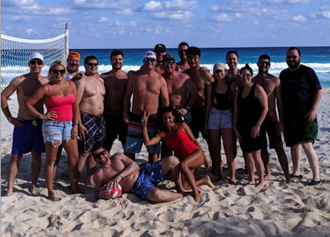 A friendly team volleyball game on a company trip to Cancun