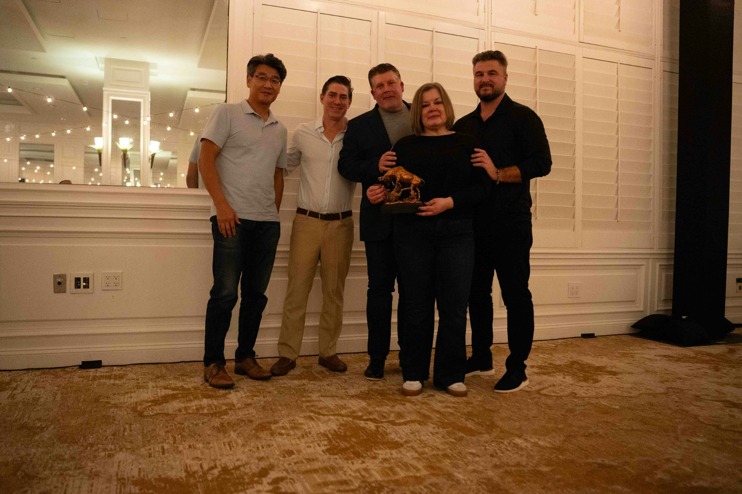 Linda Perez accepting an internal Employee of the Year award from leadership at a company trip, Miami 2025
