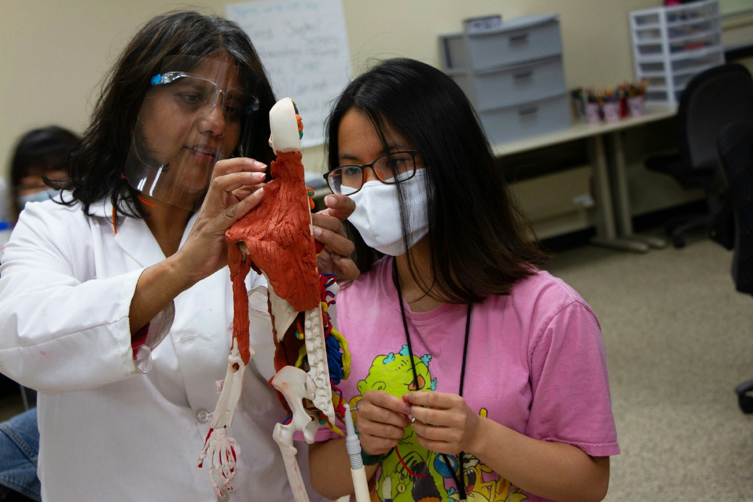 INSTRUCTOR PROVIDES GUIDANCE FOR BIO-MEDICAL STUDENT