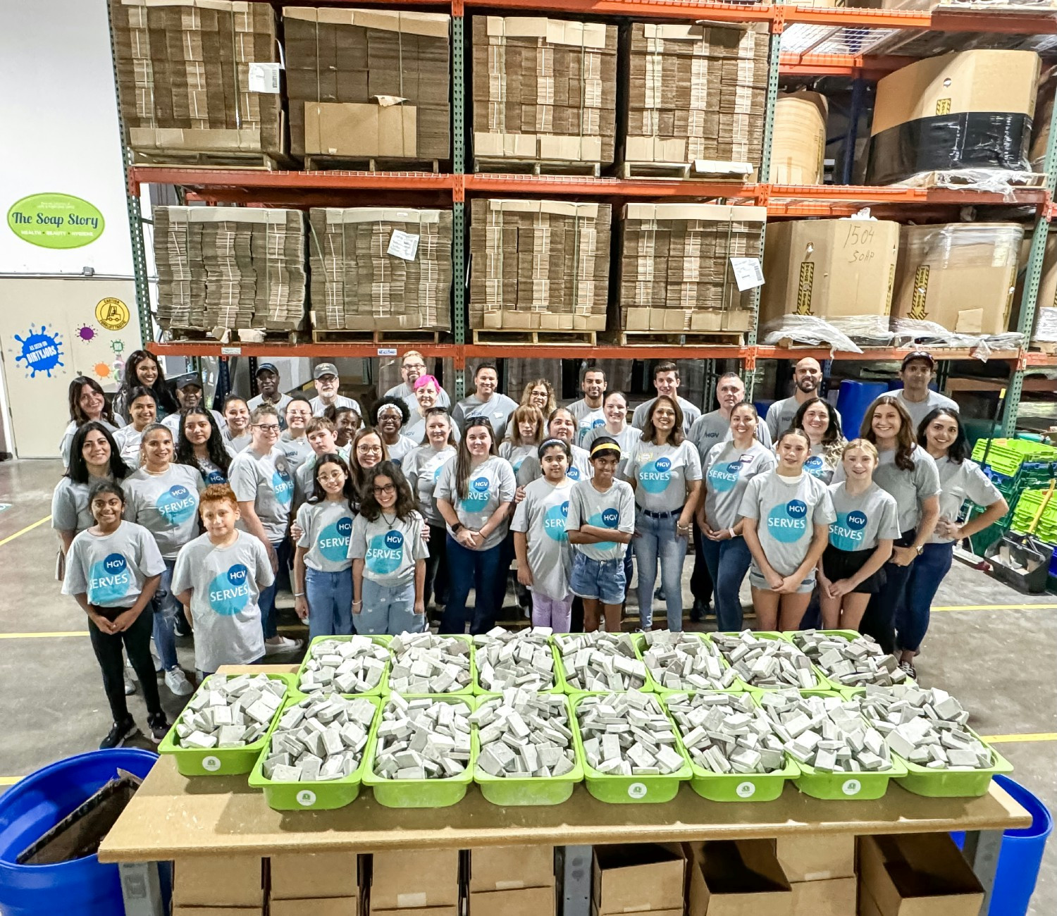 HGV team members and family members volunteering with non-profit partner, Clean The World. 