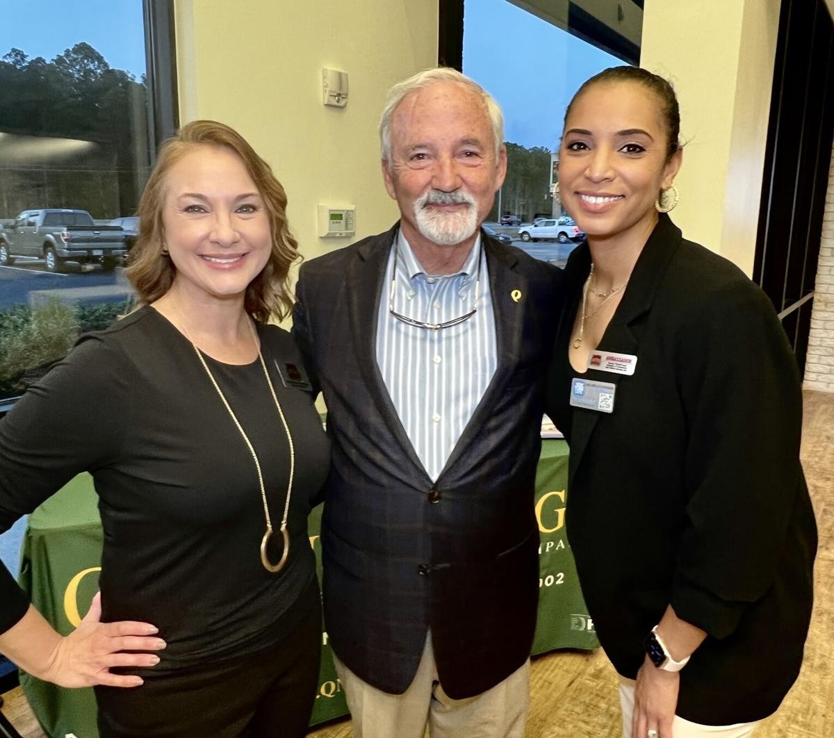 CEO & President (center) celebrating the grand opening of a new branch with community members