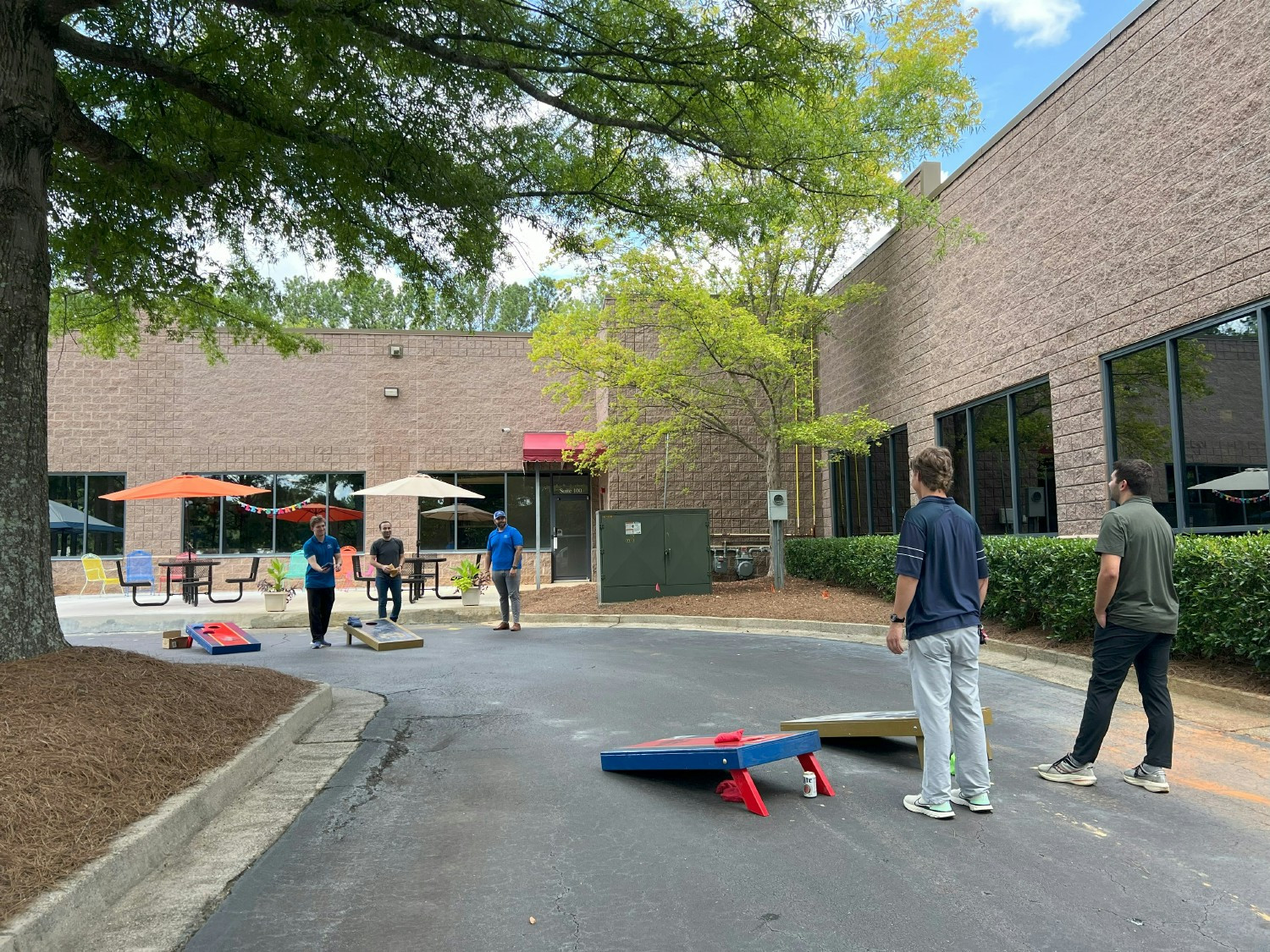 Several times a year the staff goes out back to connect and recharge with some good food and cornhole.