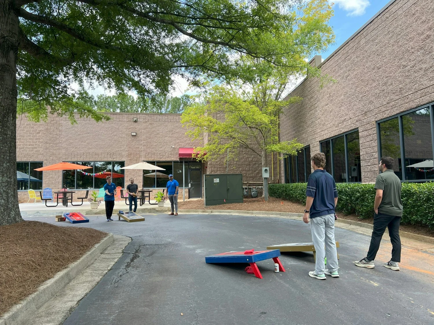 Several times a year the staff goes out back to connect and recharge with some good food and cornhole.