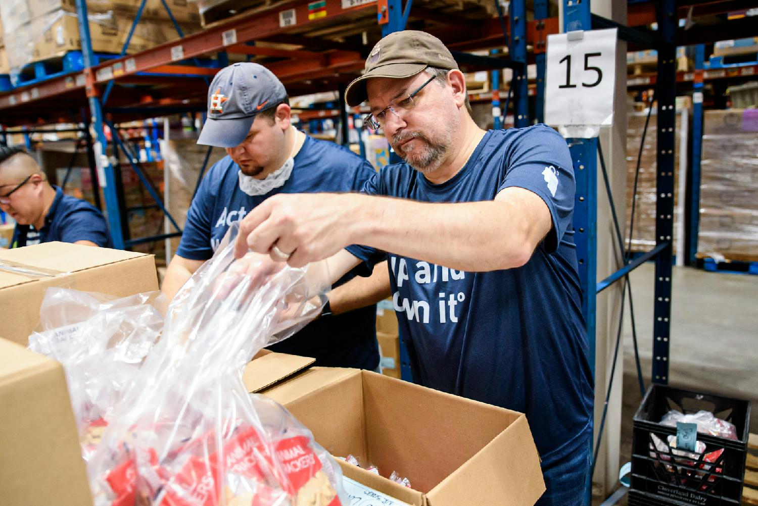 The BrandExtract team helps sort food donations at the Houston Food Bank.