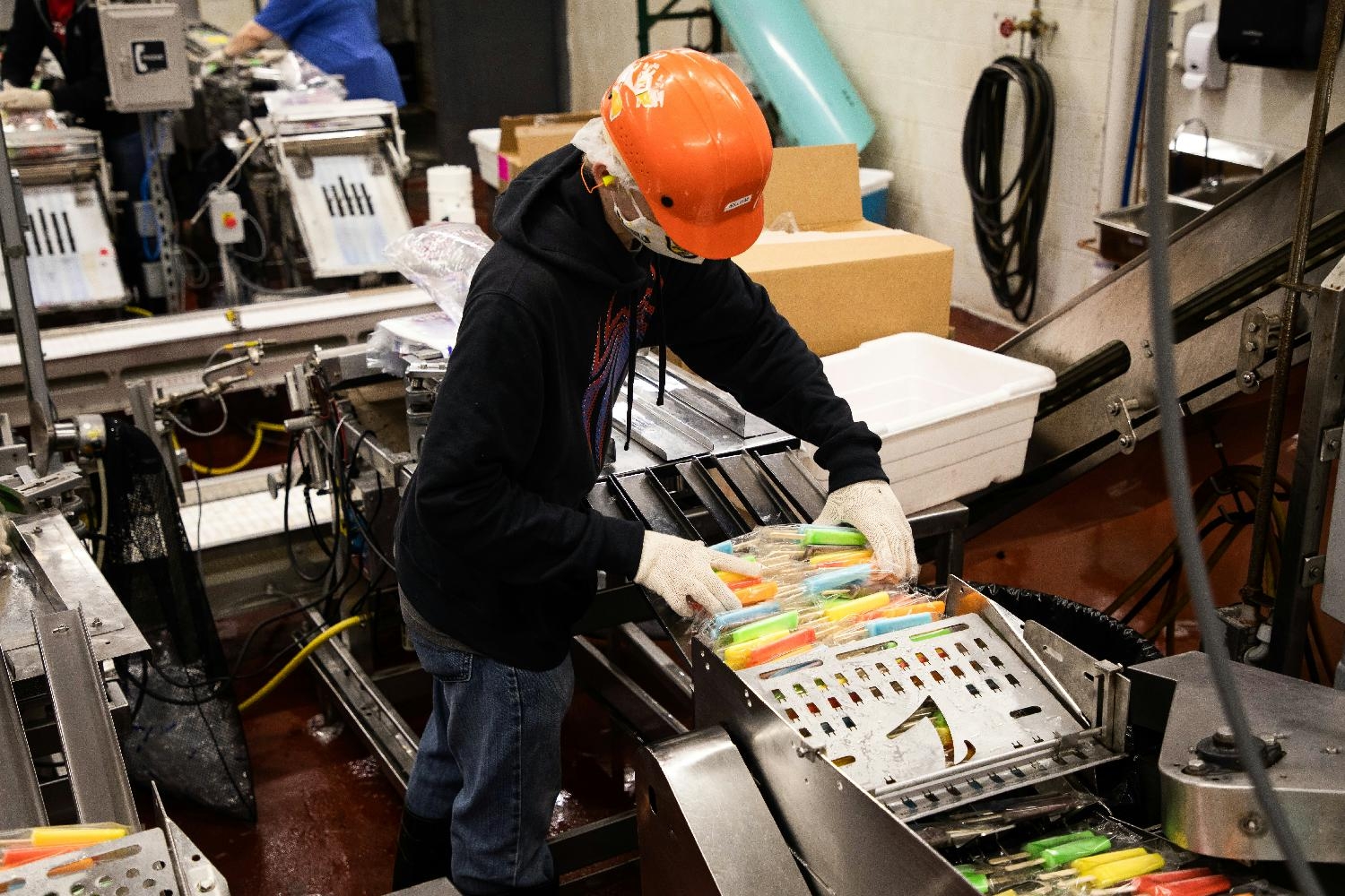Production employee hand-packing Ziegenfelder's Rainbow Array Twinpops.
