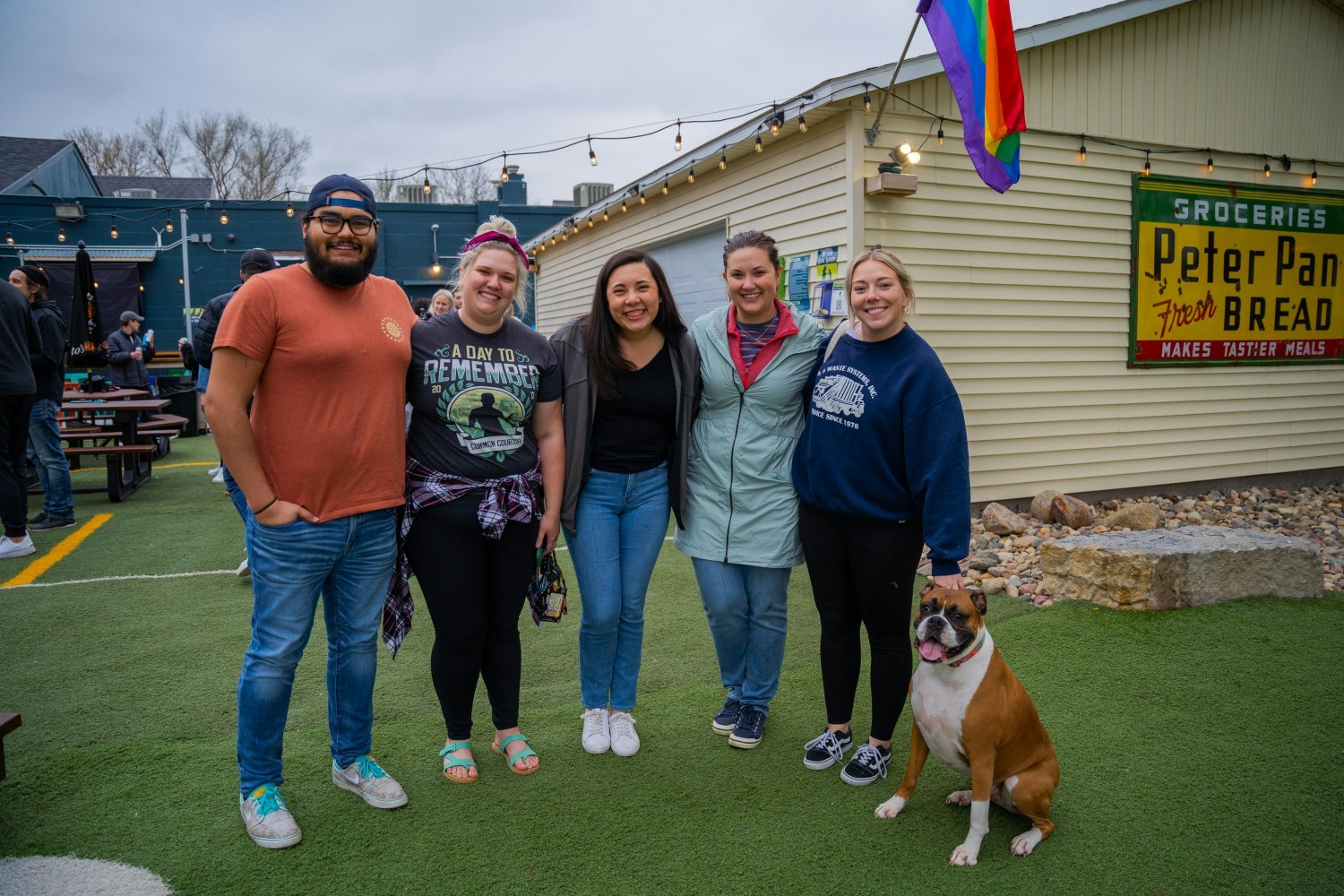 Employees socializing with fellow coworkers and their furry 
friends at a Buildertrend outing.