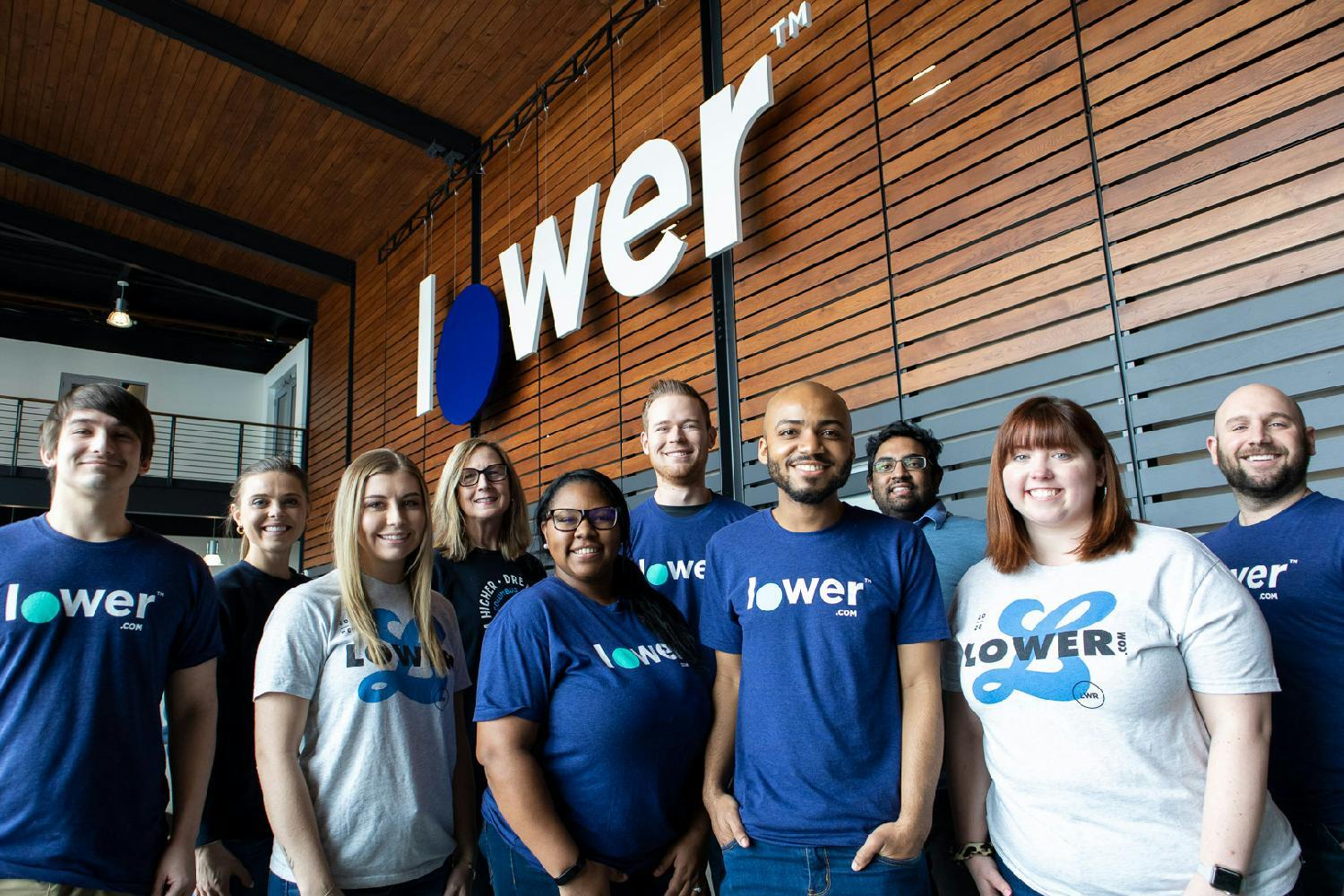 Employees stand in the atrium of the new Lower.com HQ in New Albany