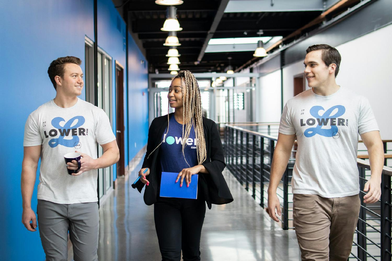 Team members walking throough the halls of Lower.com HQ.