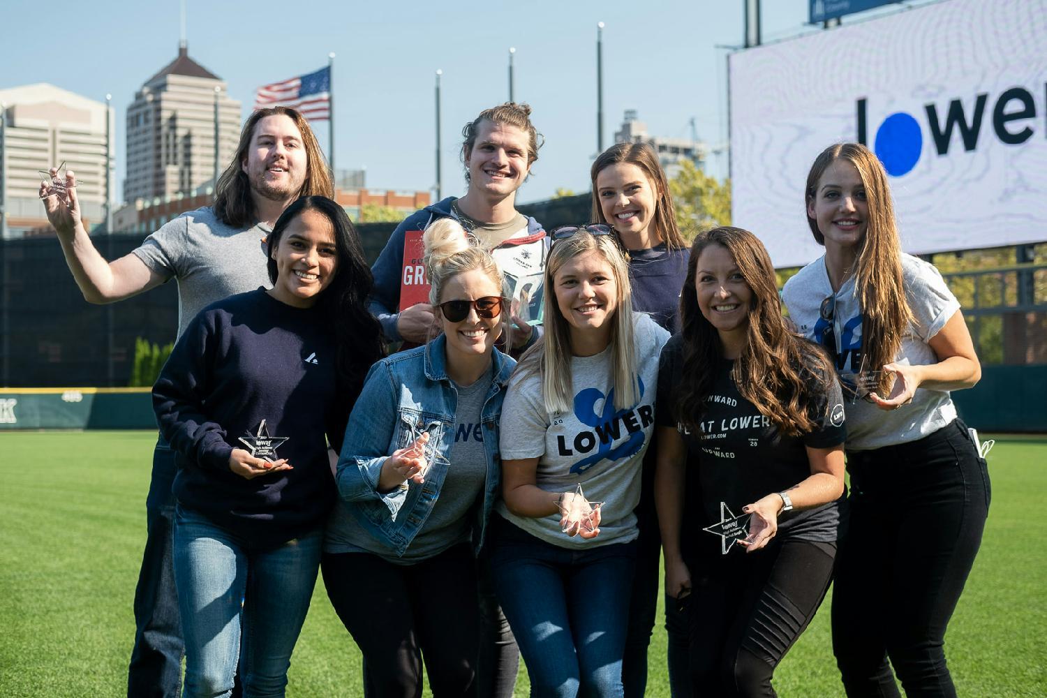 Employees pose during the Lower.com Annual Awards ceremony at Huntington Park.