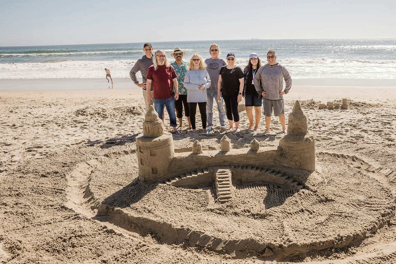 Sandcastle Building Event: With no physical offices, we meet throughout the year to build connections and have fun.