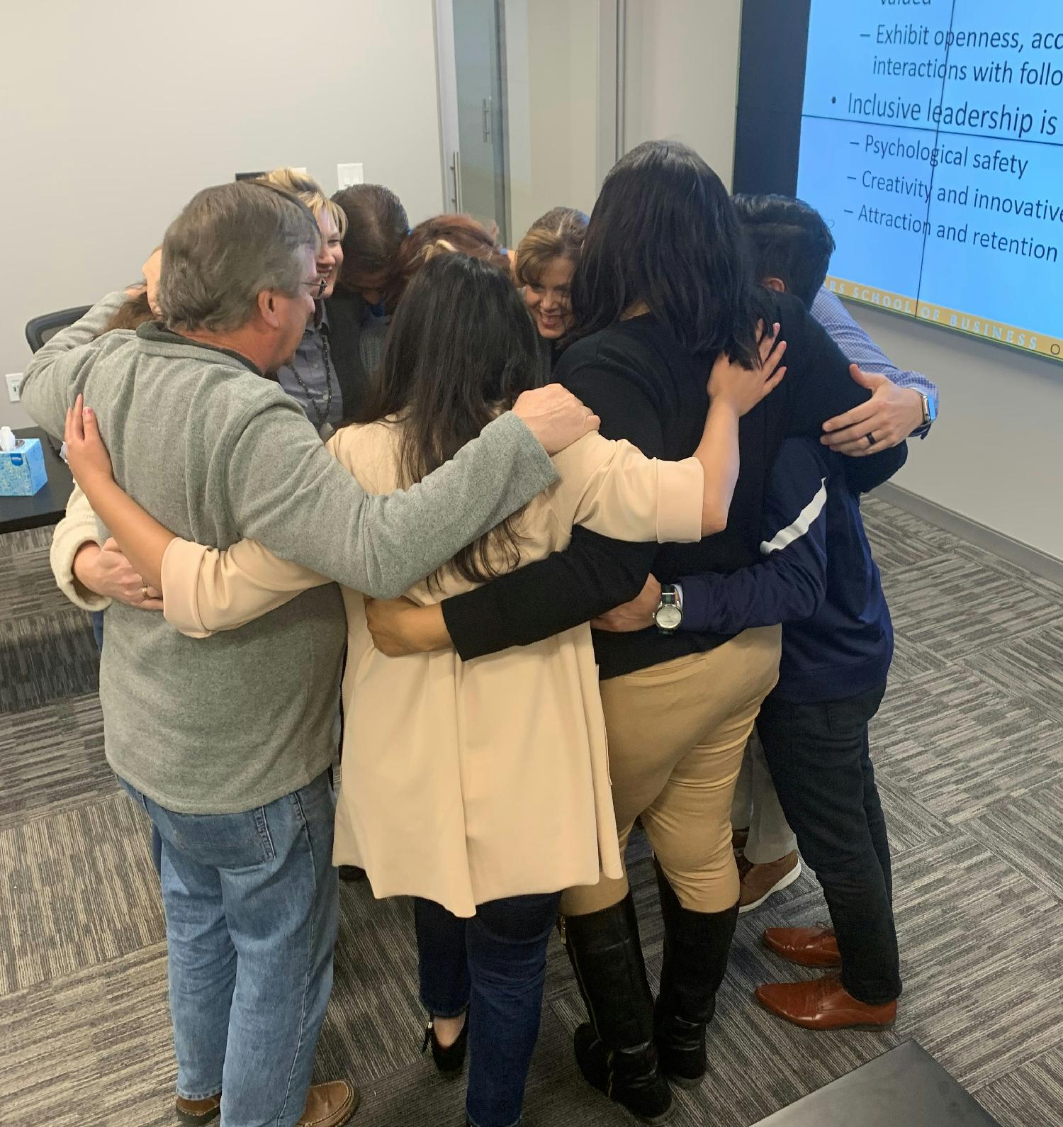 GRACE committee members celebrate Stinnett’s first Inclusion and Diversity meeting by “Caring Greatly” with a hug.