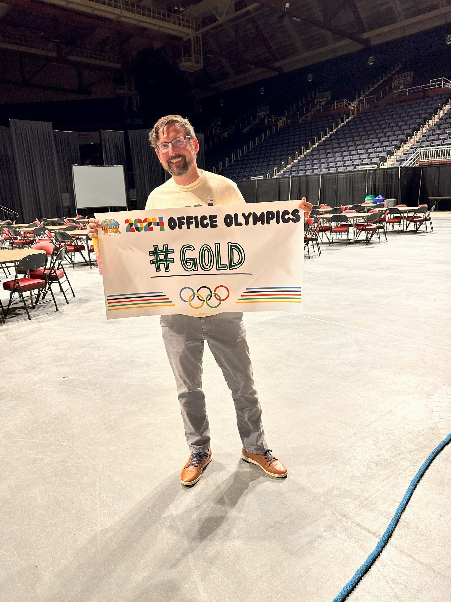 A team member posing after winning a round of Office Olympics!