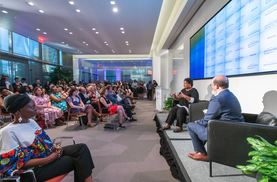 Stacey Abrams speaking to DF staff and guests at our 5th anniversary party. Abrams pictured with President, Joe Goldman.