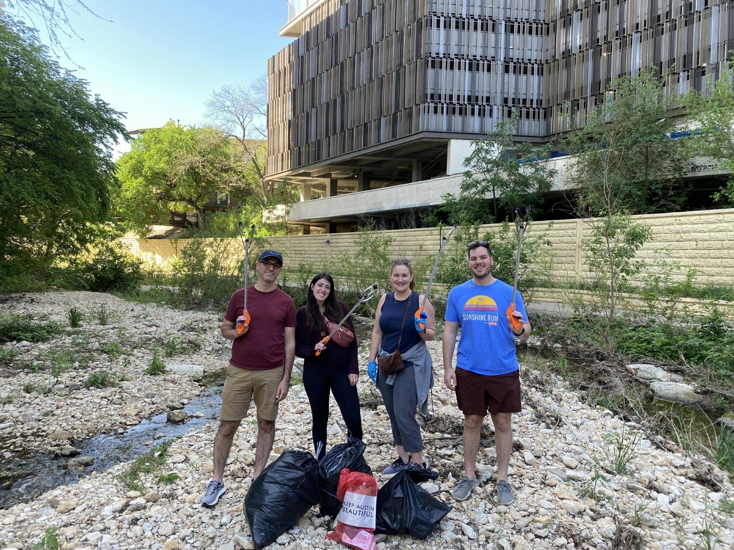 Colleagues in Austin, Texas volunteer for the 2023 Keep Austin Beautiful Creek Cleaning initiative 