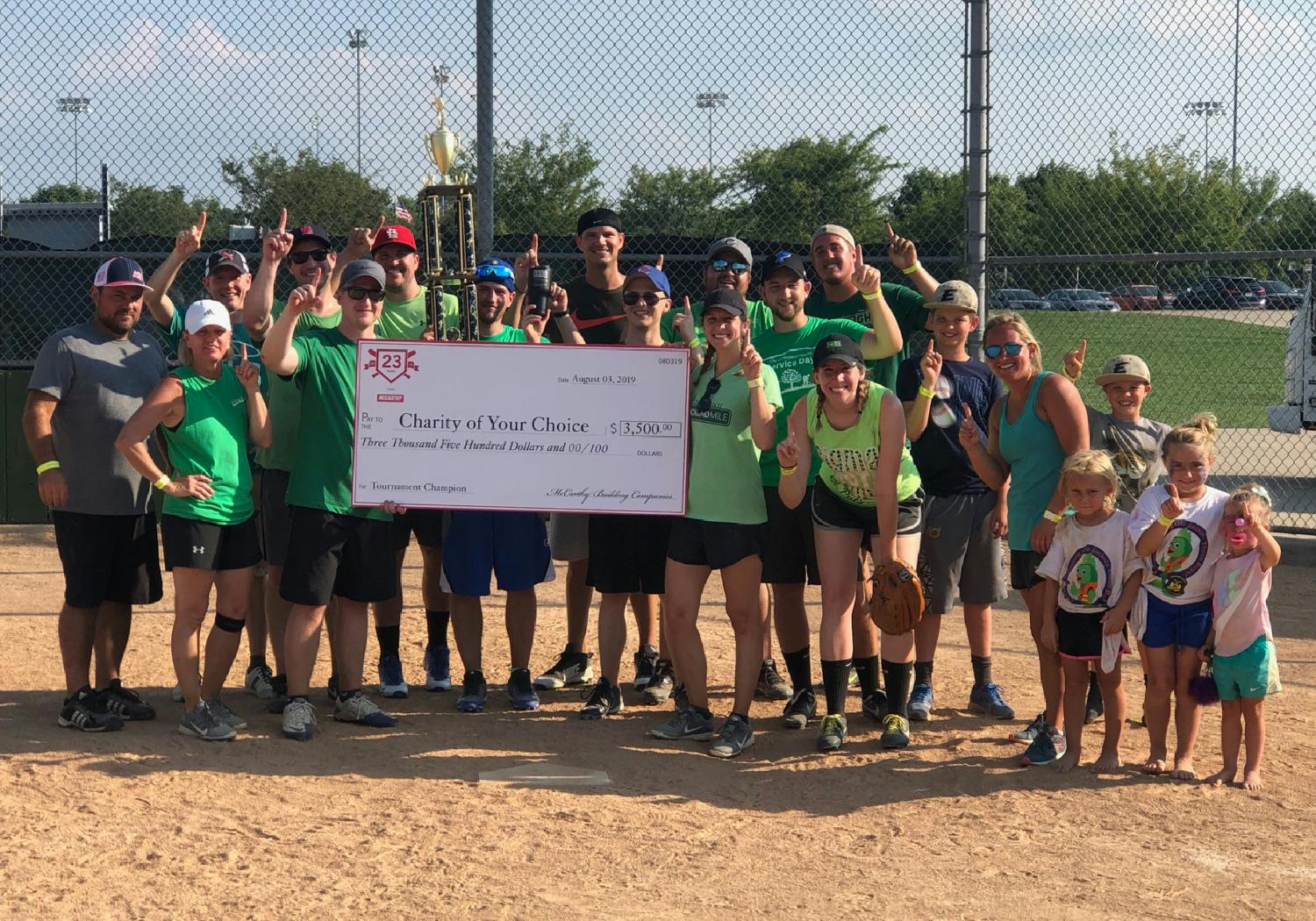 The St. Louis team celebrating their softball tournament win which raised $3,500 for Friends of Children with Cancer.