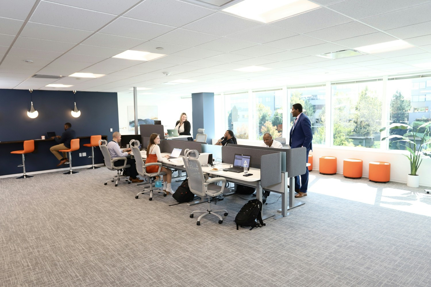 Avint employees collaborating in the open office area.