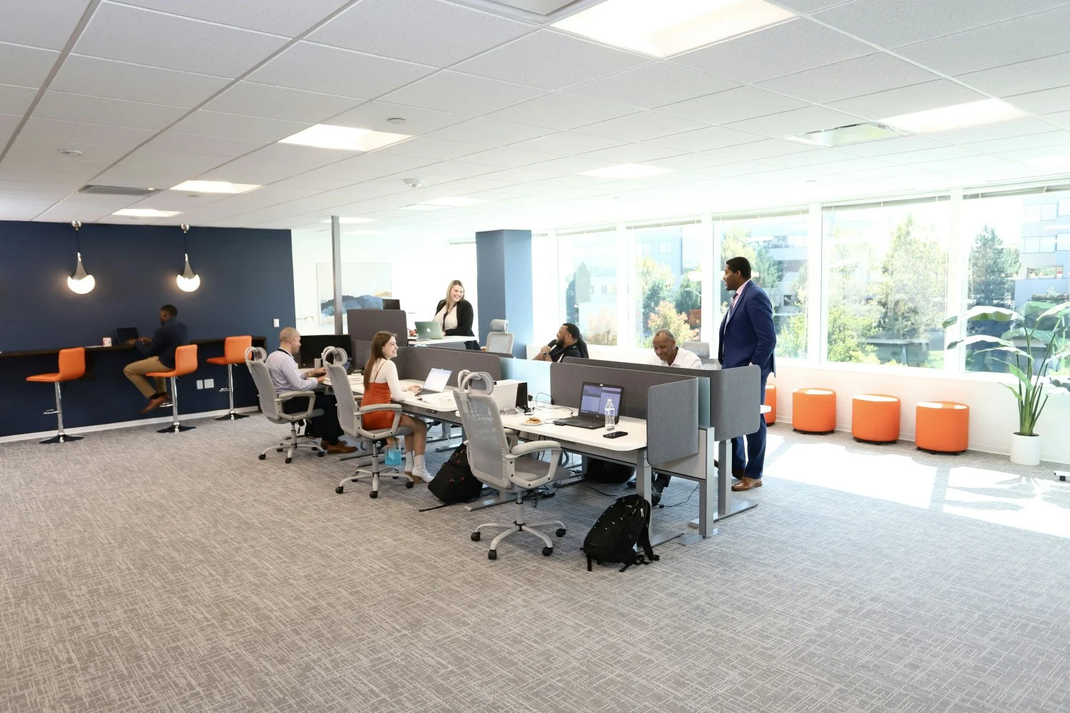 Avint employees collaborating in the open office area.