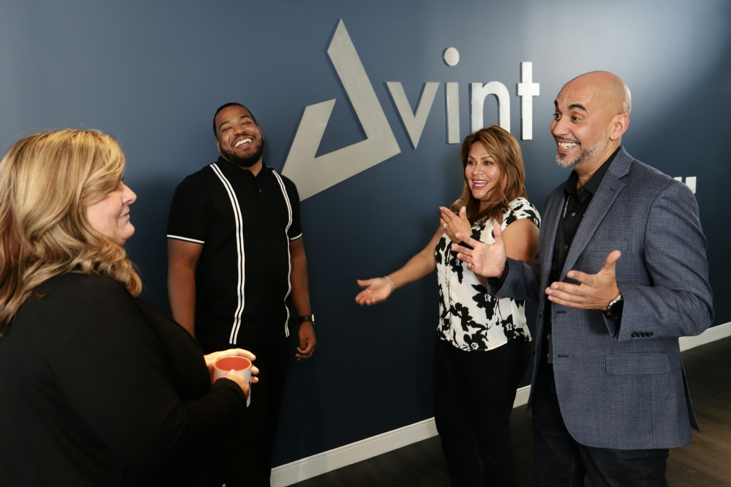 Amy, DeLante, Ines and Fred talking in the main entrance hallway.