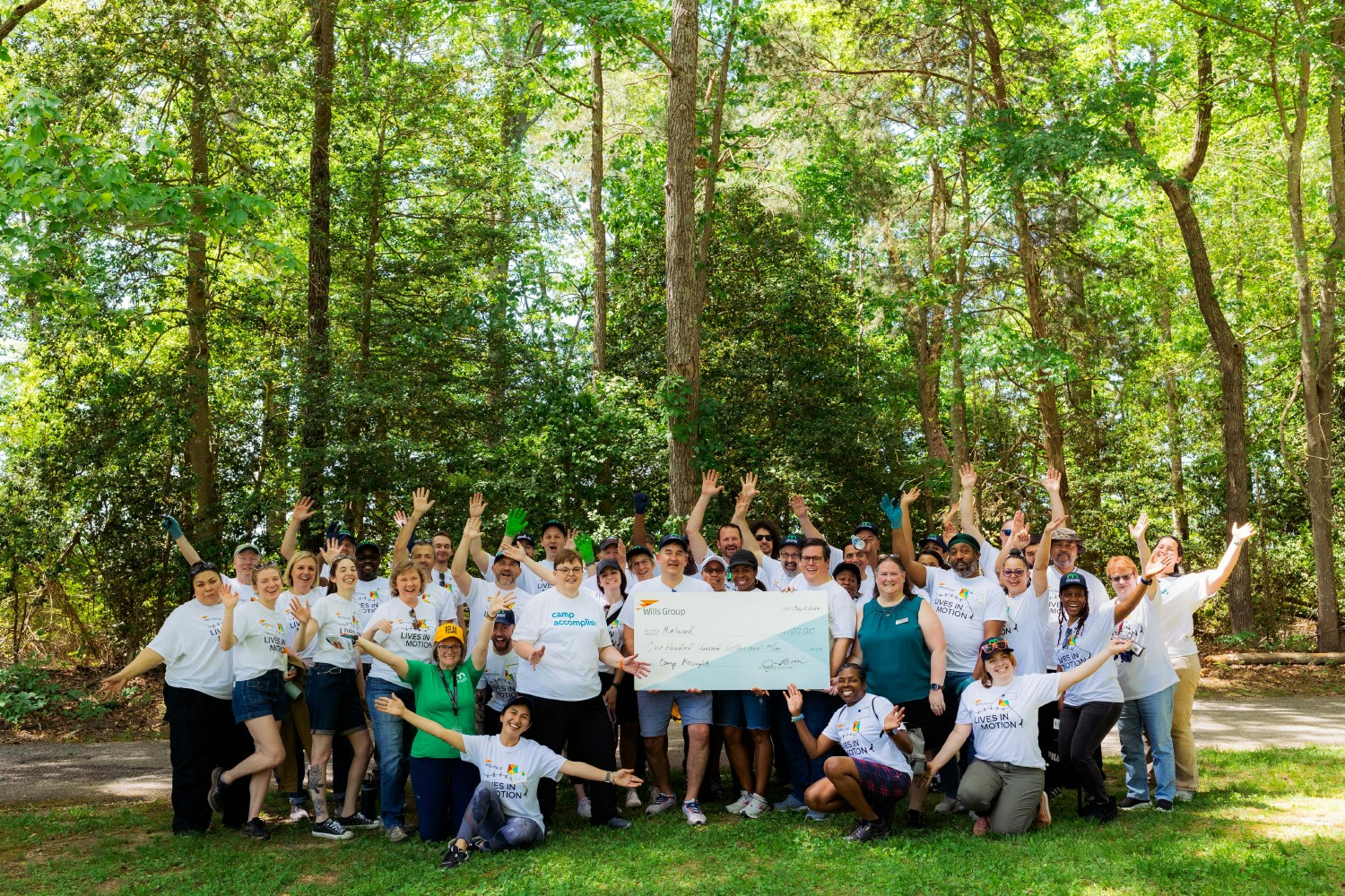 Wills Group employees proudly volunteer at Melwood Camp Accomplish in Nanjemoy, MD, while presenting a $100,000 grant.
