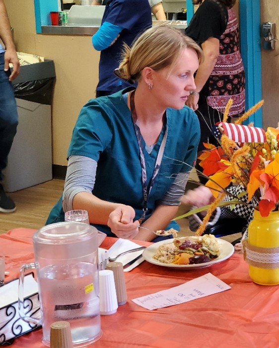 Jessica feeding a resident for our Annual Thanksgiving Luncheon