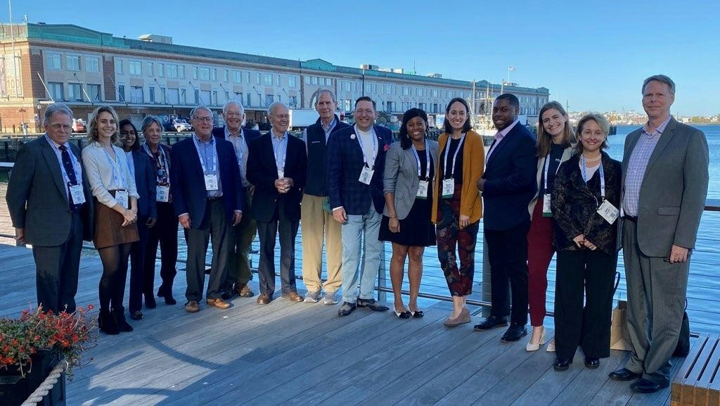 Staff pictured alongside several board members while attending a conference