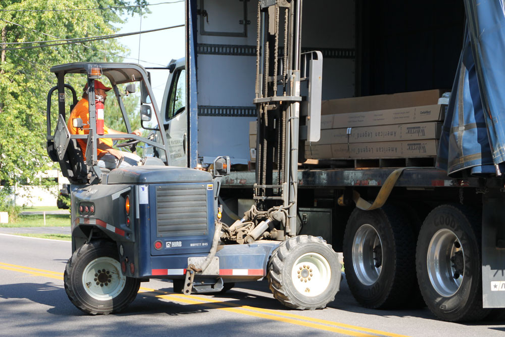 Long term employee on-site at a customer location making a delivery.
