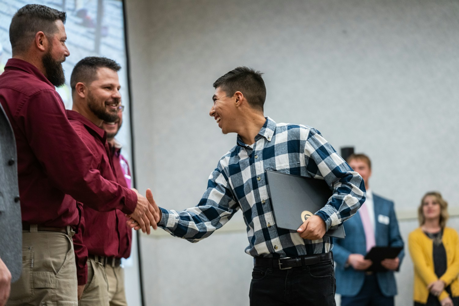 A student receiving his certificate at his graduation from NLC's Telecommunication Lineworker Program.