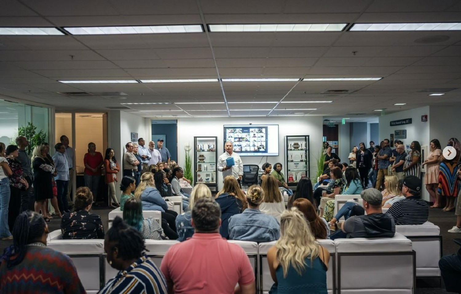 Wesley Financial Group employees attend their monthly all-staff meeting. 