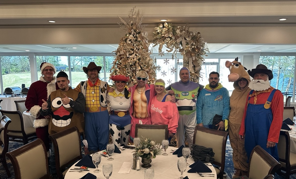 The Executive and Management Teams (and Mitch) dressed up for our annual Christmas Party ready to greet the Team!