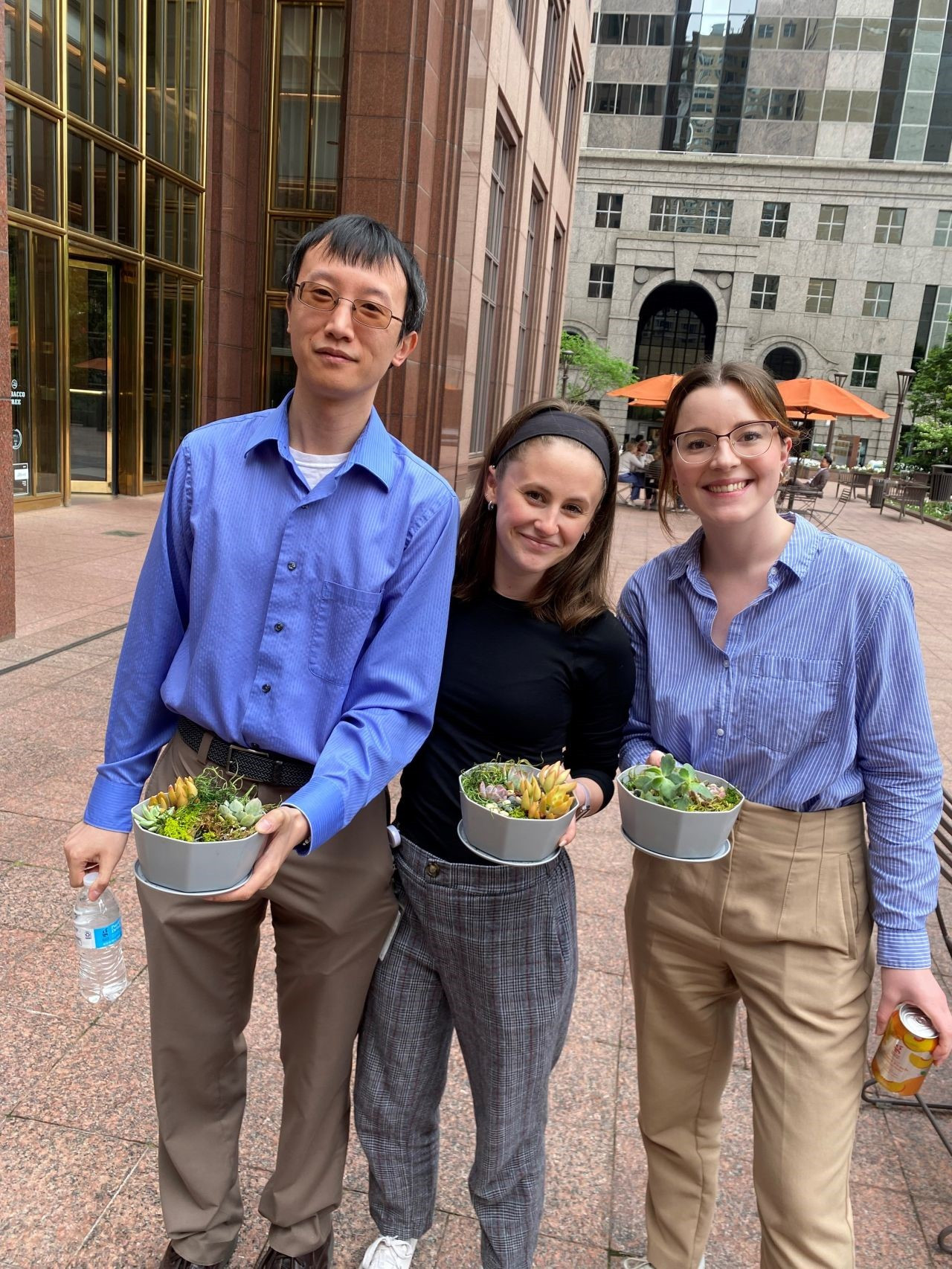 Team members showing off their DIY succulent gardens at an ERG-hosted event. 