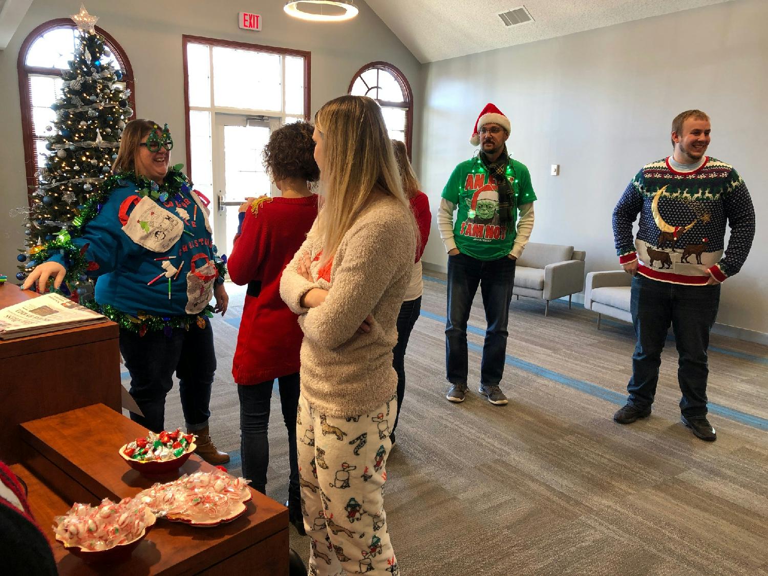 Evansville staff gathers for annual ugly Christmas sweater contest judging. 