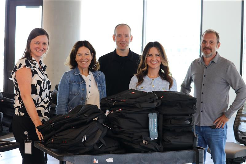 Packing backpacks for our annual Books & Backpacks initiative in Austin, ensuring children have school supplies needed
